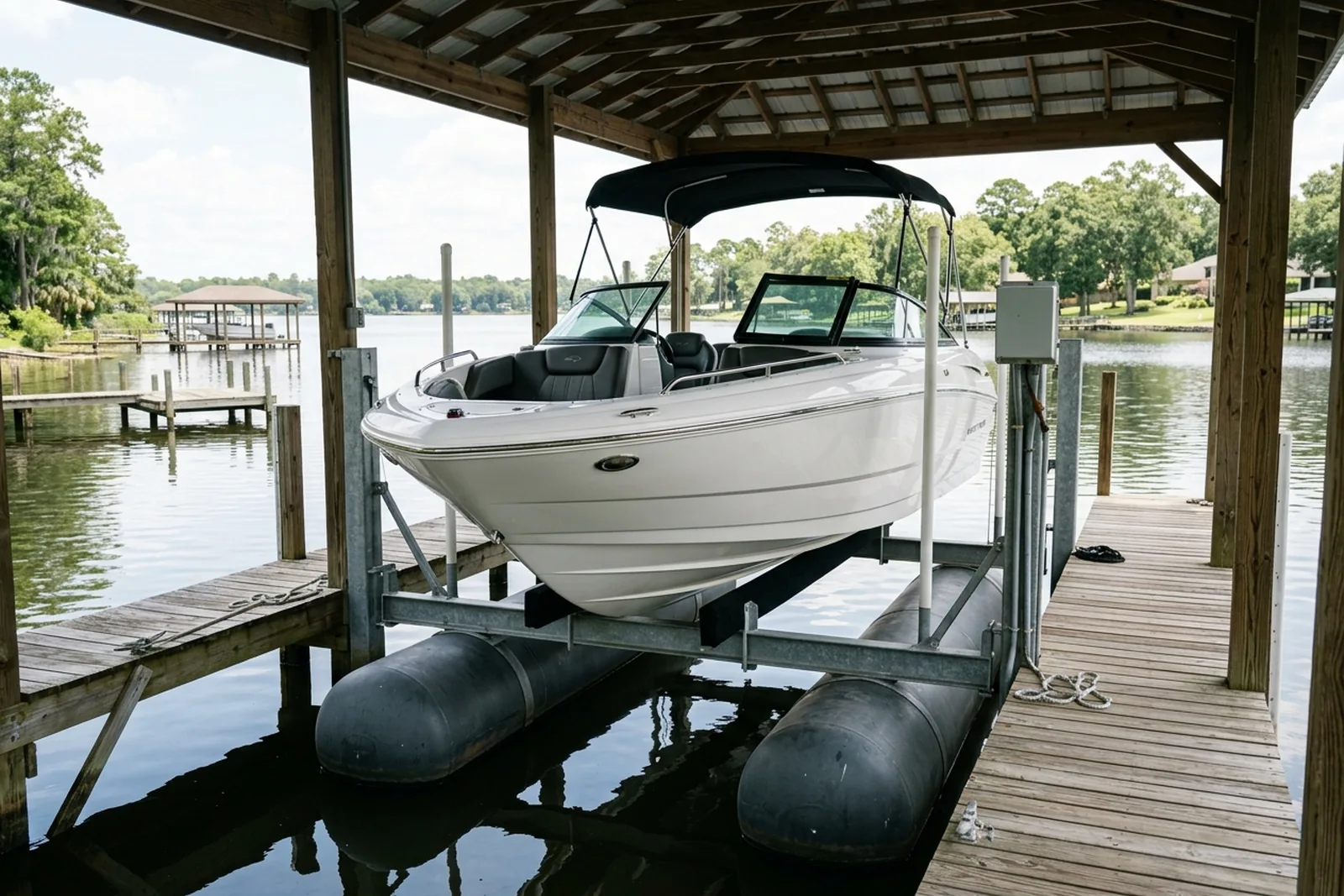 Boat raised on an air lift in a covered dock slip
